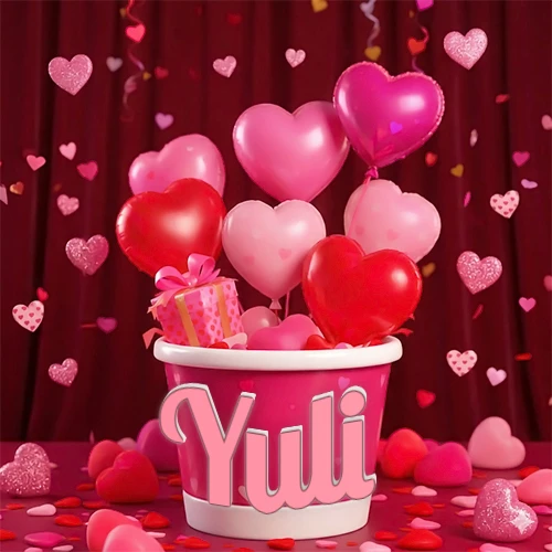 Cubo rosa lleno de globos en forma de corazones rojos y rosas, con pequeños regalos esparcidos sobre un fondo de cortinas de terciopelo rojo que sugieren un ambiente festivo cálido. El nombre Yuli está escrito en el diseño.